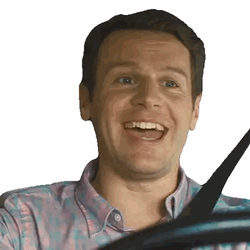 Man In Plaid Shirt Smiling Holding Seat Belt Sticker