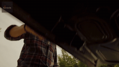 Man In Plaid Shirt Standing Before Nimble Sign GIF