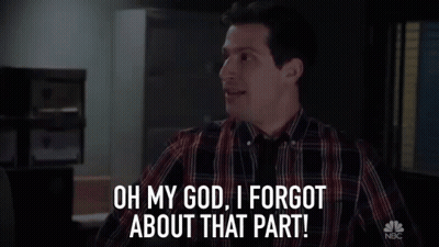 Man In Plaid Shirt Standing In Dark Room GIF