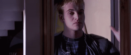 Man In Plaid Shirt Standing In Doorway GIF