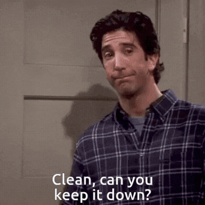Man In Plaid Shirt Standing In Front Of Door GIF
