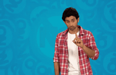 Man In Plaid Shirt Standing In Front Of Maaf Kar Bhai Sign GIF