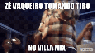 Man In Plaid Shirt Standing In Front Of No Villa Mix Sign GIF