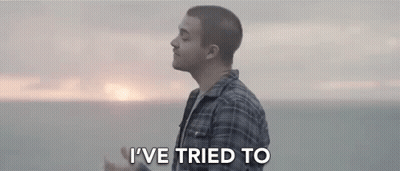 Man In Plaid Shirt Standing In Front Of Ocean GIF