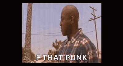Man In Plaid Shirt Standing In Front Of Palm Tree And Power Line GIF