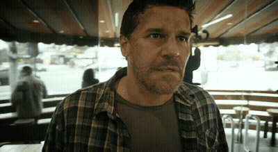 Man In Plaid Shirt Standing In Front Of Window GIF
