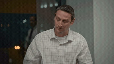 Man In Plaid Shirt Standing In Room GIF