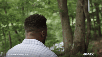 Man In Plaid Shirt Standing In Woods With NBC Logo GIF