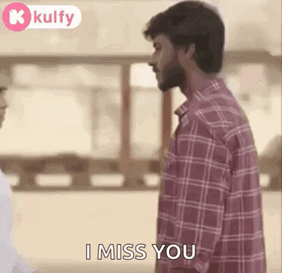 Man In Plaid Shirt Standing Next To Man In White Shirt GIF