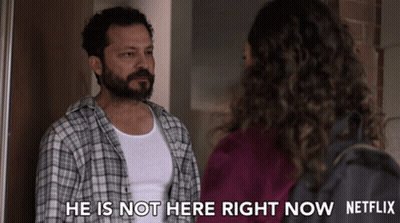 Man In Plaid Shirt Standing Next To Woman Saying He Is Not Here Right Now GIF