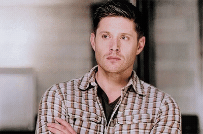 Man In Plaid Shirt Standing With Arms Crossed Looking Away GIF