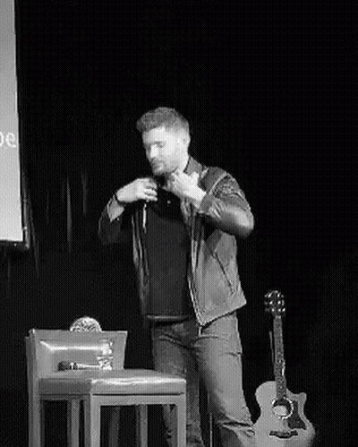 Man In Plaid Shirt Standing With Arms Crossed Looking Away GIF
