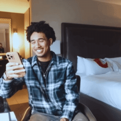 Man in Plaid Shirt Taking Selfie