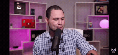 Man In Plaid Shirt Talking Into Microphone GIF