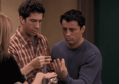 Man In Plaid Shirt Talking To Man In Blue Shirt GIF