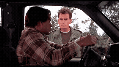 Man In Plaid Shirt Talking To Man In Green Jacket GIF
