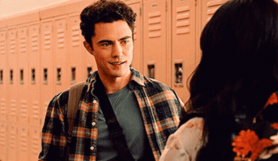 Man In Plaid Shirt Talking To Woman GIF