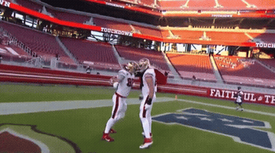 Man in Plaid Shirt Waving Says Kittle First TD
