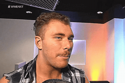 Man In Plaid Shirt With Microphone In Mouth GIF