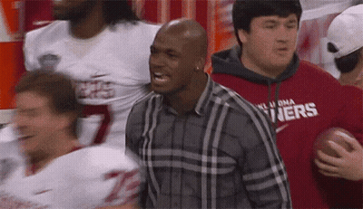 Man In Plaid Shirt With Oklahoma Holding Football GIF