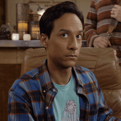 Man In Plaid Shirt With Sheep T-Shirt Looking At Camera GIF