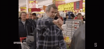 Man In Plaid Shirt With Shopping Cart In Crowded Grocery Store GIF