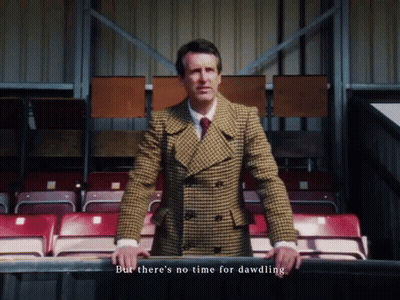 Man In Plaid Suit In Stadium But There's No Time For Dawdling GIF