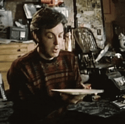 Man In Plaid Sweater Reading Book GIF