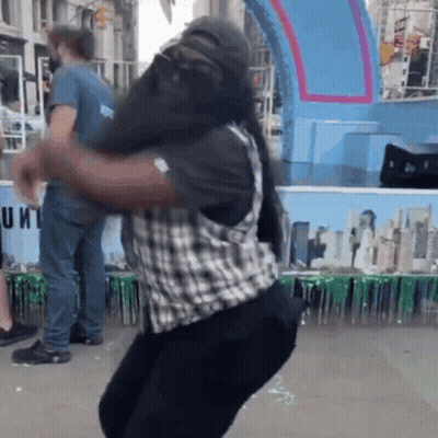 Man In Plaid Vest Dancing By Unit Sign GIF