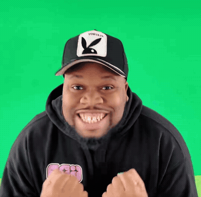 Man In Playboy Hat And Black Hoodie Smiling GIF