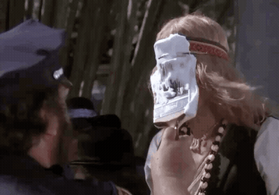 Man In Police Hat Holding Paper To Face GIF