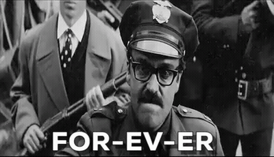 Man In Police Uniform Holding Gun GIF