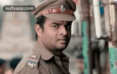 Man In Police Uniform Looking At Camera GIF