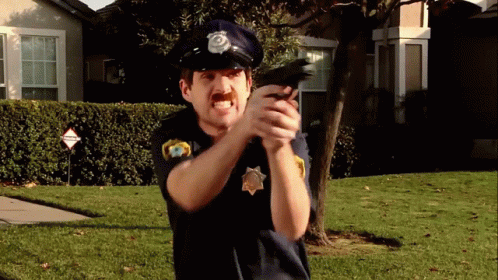 Man In Police Uniform Pointing Gun GIF