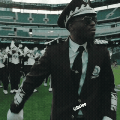 Man In Police Uniform Saluting In Stadium GIF