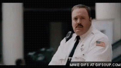 Man In Police Uniform Sitting In Room GIF