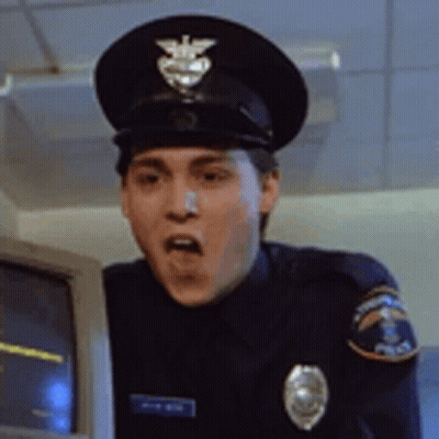 Man In Police Uniform Standing In Front Of Computer Monitor GIF