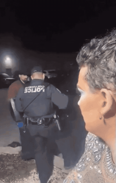Man In Police Uniform Talking To Woman In Dress GIF