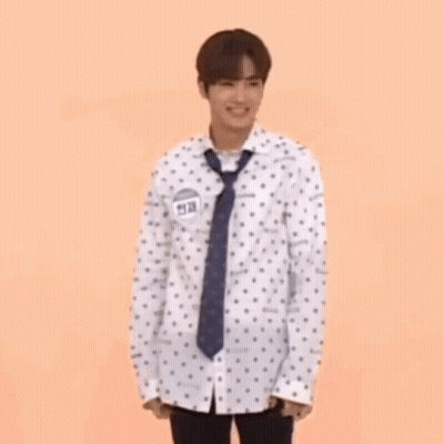 Man In Polka Dot Shirt And Tie Holding Hula Hoop GIF
