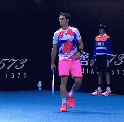 Man In Polo Shirt Walking On Blue Court GIF