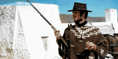 Man In Poncho Holding Gun Gravello2020 GIF
