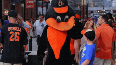 Man In Powell 26 Jersey Next To Mascot GIF