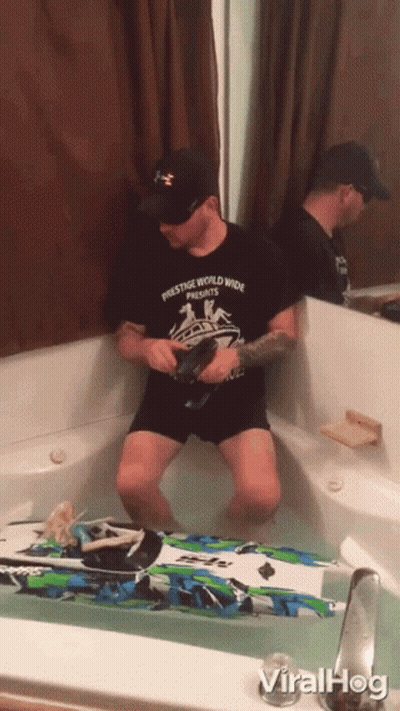 Man In Prestige Worldwide Shirt Sitting In Bathtub GIF