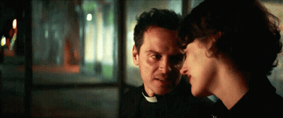 Man In Priest Collar And Woman Looking At Each Other GIF