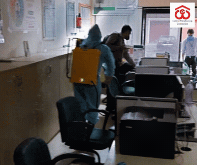 Man In Protective Suit Spraying Room GIF