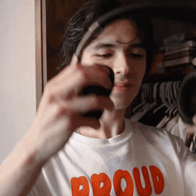 Man In Proud Shirt Holding Something GIF