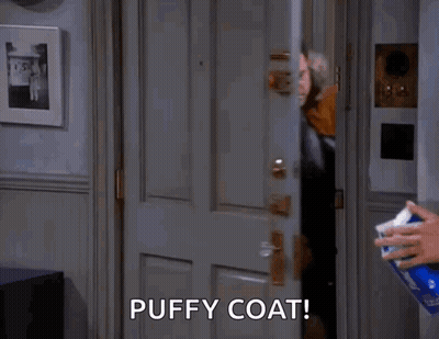 Man In Puffy Coat Standing In Doorway With Tissues GIF