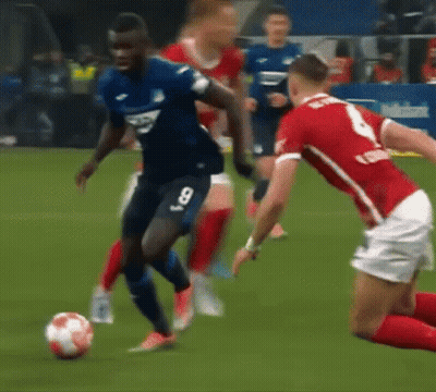 Man In Puma Sweatshirt Kicking Soccer Ball On Field GIF