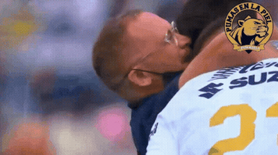Man In Pumas Jersey Kissing Another GIF
