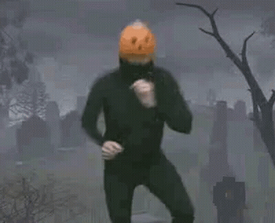 Man In Pumpkin Mask Dancing In Cemetery GIF